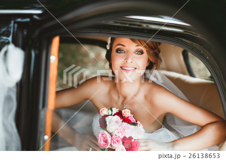 Beautiful bride sitting in wedding car Beautiful bride sitting in wedding car 26138653