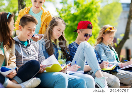 group of students with notebooks at school yard 26140797