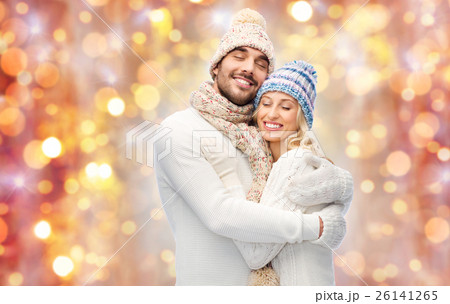 smiling couple in winter clothes hugging 26141265