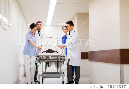 medics with woman on hospital gurney at emergency 26141357
