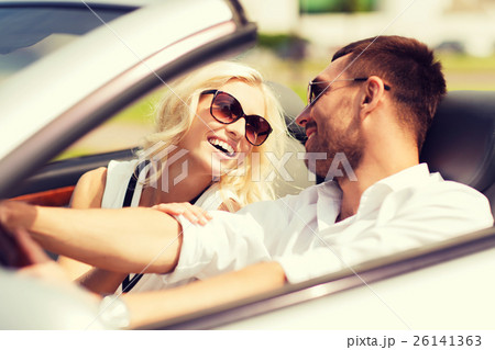 happy man and woman driving in cabriolet car happy man and woman driving in cabriolet car 26141363