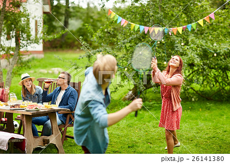 happy friends playing badminton at summer garden 26141380