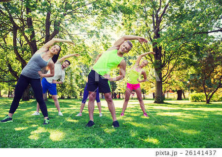 group of friends or sportsmen exercising outdoors 26141437