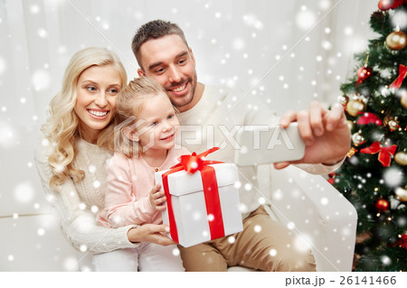family taking selfie with smartphone at christmas 26141466