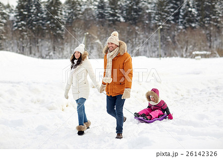 happy family with sled walking in winter forest 26142326