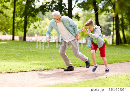grandfather and grandson racing at summer park grandfather and grandson racing at summer park 26142364