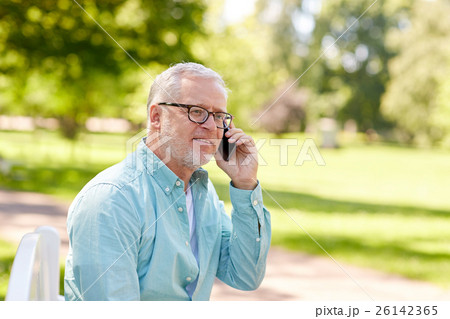 senior man calling on smartphone at summer park senior man calling on smartphone at summer park 26142365
