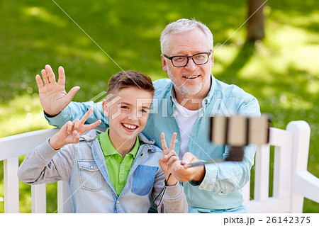 old man and boy taking selfie by smartphone old man and boy taking selfie by smartphone 26142375