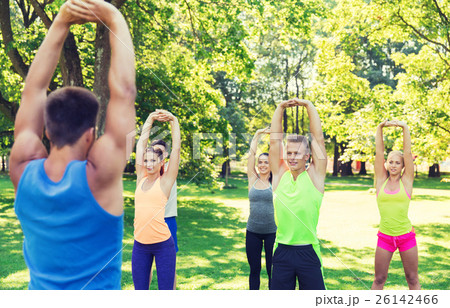 group of friends or sportsmen exercising outdoors group of friends or sportsmen exercising outdoors 26142466
