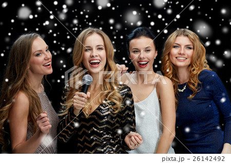 happy young women with microphone singing karaoke happy young women with microphone singing karaoke 26142492