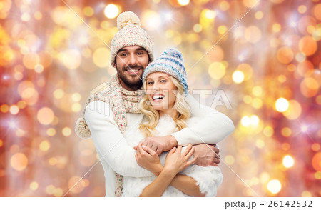 smiling couple in winter clothes hugging smiling couple in winter clothes hugging 26142532