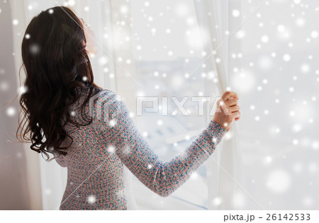 close up of woman opening window curtains close up of woman opening window curtains 26142533