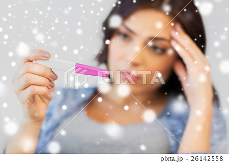 close up of sad woman with home pregnancy test close up of sad woman with home pregnancy test 26142558