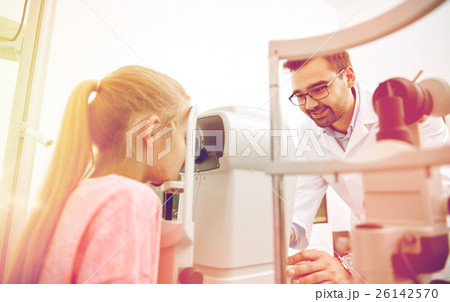 optician with tonometer and patient at eye clinic optician with tonometer and patient at eye clinic 26142570