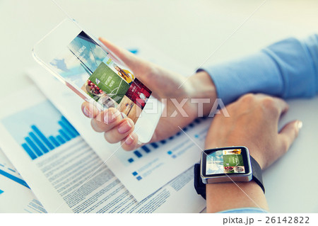 close up of hands with smart phone and watch close up of hands with smart phone and watch 26142822