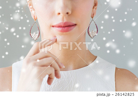 close up of beautiful woman face with earrings close up of beautiful woman face with earrings 26142825