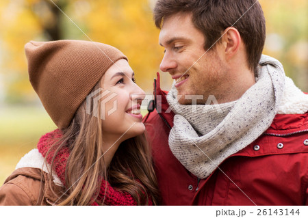close up of happy couple walking in autumn park close up of happy couple walking in autumn park 26143144