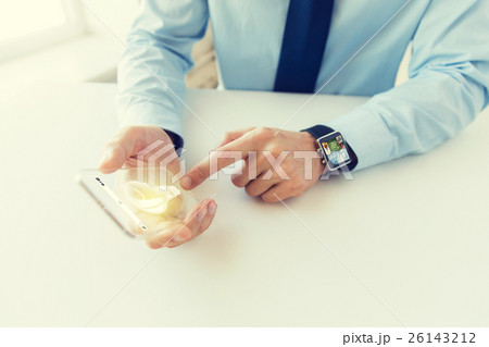 close up of hands with smart phone and watch 26143212