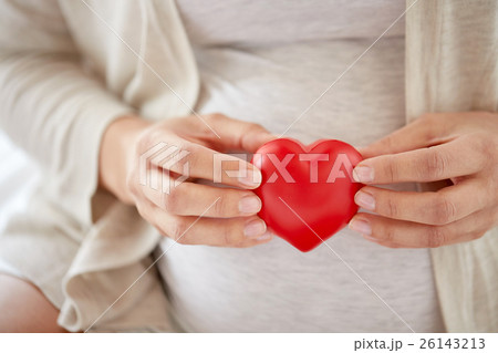 close up of pregnant woman with red heart 26143213