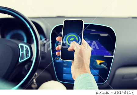 man driving car and setting eco mode on smartphone 26143217