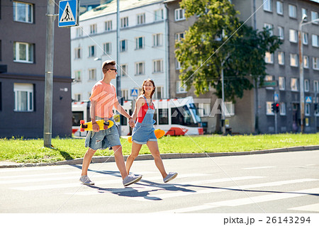 teenage couple with skateboards on city street teenage couple with skateboards on city street 26143294