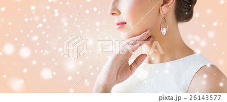 close up of beautiful woman face with earring 26143577