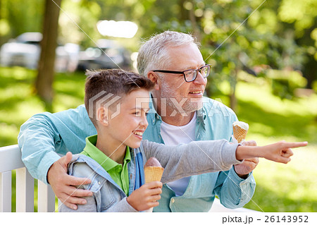 old man and boy eating ice cream at summer park 26143952