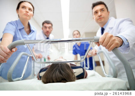 medics and patient on hospital gurney at emergency 26143968