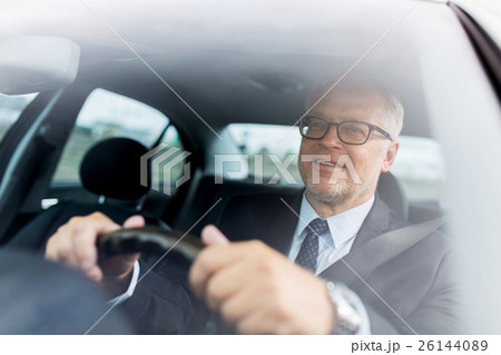 happy senior businessman driving car 26144089