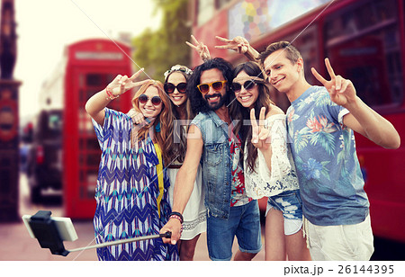 hippie friends with smartphone on selfie stick 26144395