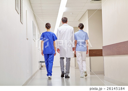 group of medics or doctors walking along hospital 26145184