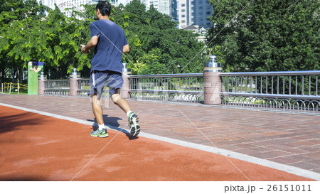 Man running in the running way in the garden park. 26151011