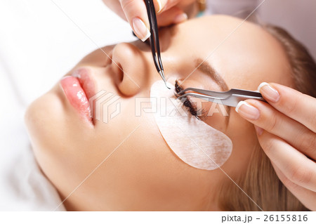 Eyelash Extension Procedure. Woman Eye with Long 26155816
