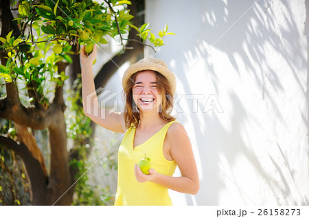 Happy female farmer working in fruit orchard Happy female farmer working in fruit orchard 26158273