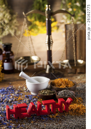 Healthy herbs on wooden table, mortar  26162775