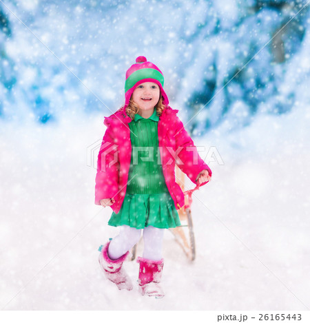 Little girl playing in snowy winter forest Little girl playing in snowy winter forest 26165443