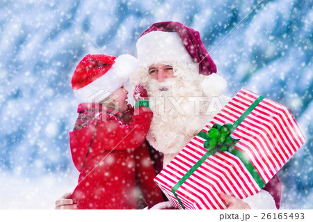 Santa Claus talking to little girl in snowy park Santa Claus talking to little girl in snowy park 26165493