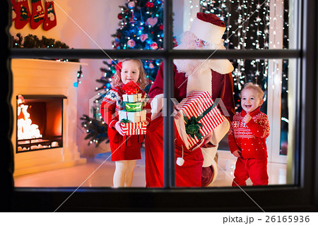 Kids and Santa opening Christmas presents Kids and Santa opening Christmas presents 26165936