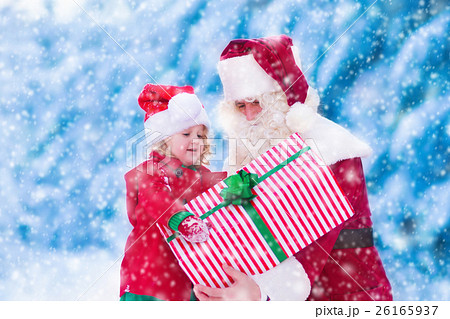 Kids and Santa with Christmas presents Kids and Santa with Christmas presents 26165937