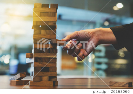 businessman gambling placing wood block on tower businessman gambling placing wood block on tower 26168066