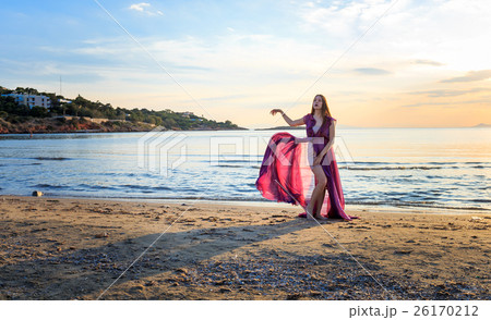 pregnant woman in purple dress posing on beach pregnant woman in purple dress posing on beach 26170212