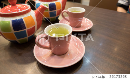 hot green tea in pink cup with colorful teapot 26173263