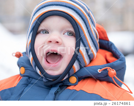 Attractive baby boy playing with the first snow Attractive baby boy playing with the first snow 26174861