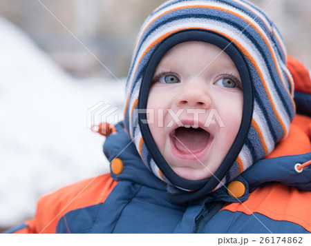 Attractive baby boy playing with the first snow Attractive baby boy playing with the first snow 26174862