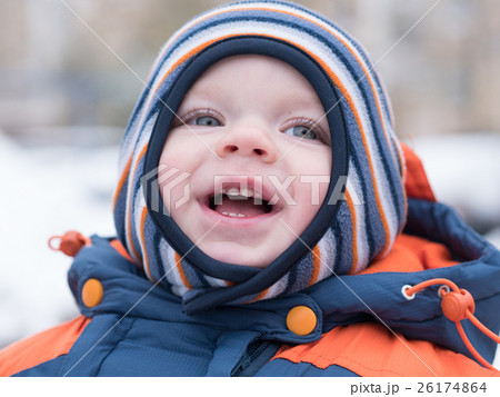 Attractive baby boy playing with the first snow Attractive baby boy playing with the first snow 26174864