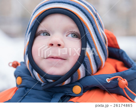Attractive baby boy playing with the first snow Attractive baby boy playing with the first snow 26174865