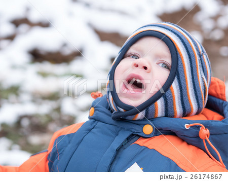 Attractive baby boy playing with the first snow Attractive baby boy playing with the first snow 26174867