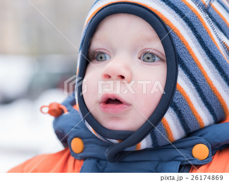 Attractive baby boy playing with the first snow Attractive baby boy playing with the first snow 26174869