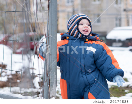 Attractive baby boy playing with the first snow Attractive baby boy playing with the first snow 26174883
