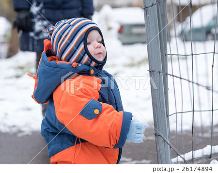 Attractive baby boy playing with the first snow Attractive baby boy playing with the first snow 26174894